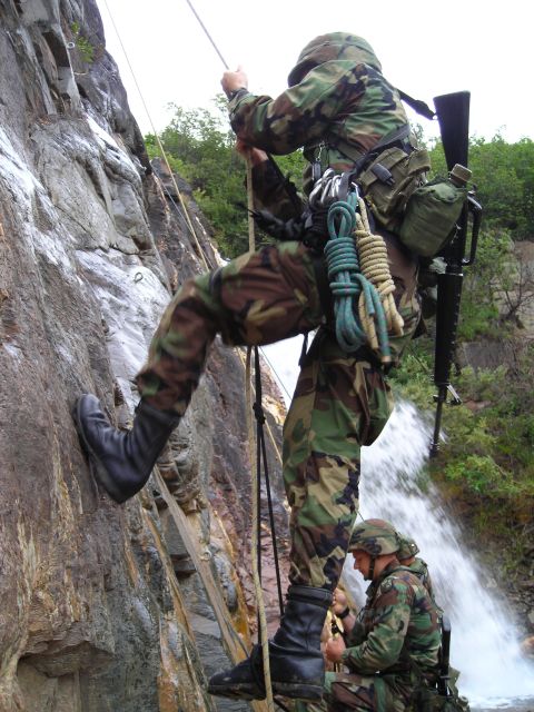 2003 Jeep TJ - Military personnel conduct rappelling training near a waterfall.