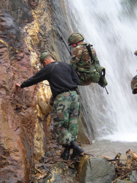 2003 Jeep TJ - Military personnel conduct rappelling training near a waterfall.