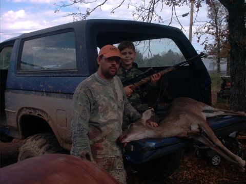 1985 Ford Bronco - Hunters pose with their deer next to a 1985 Ford Bronco.
