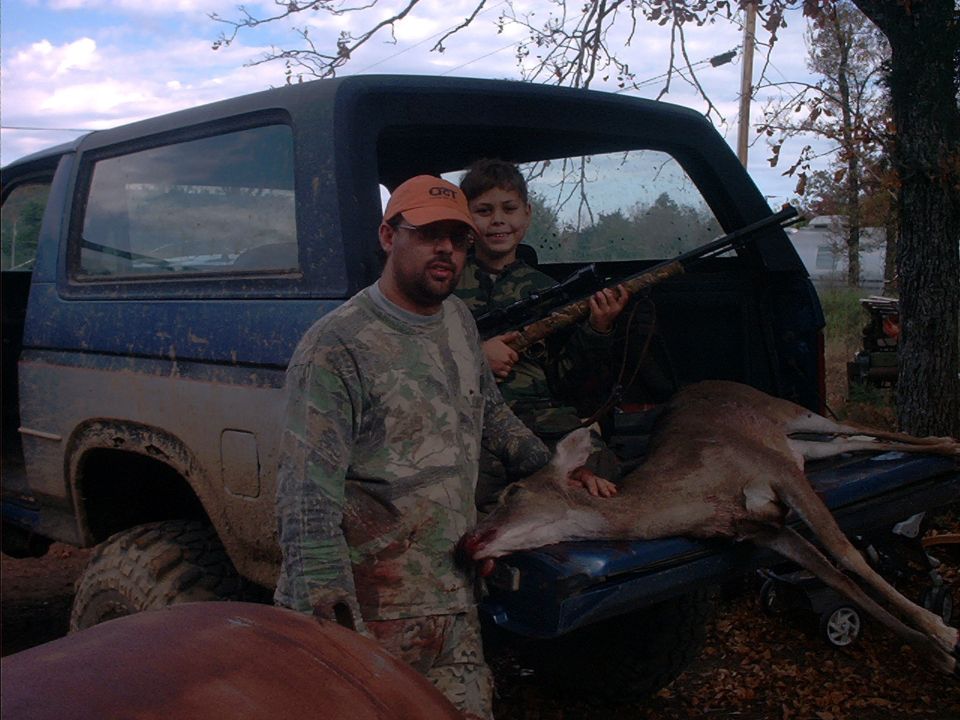 1985 Ford Bronco rear view with hunters and deer