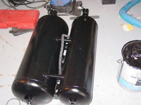 1979 Ford Bronco - Two black propane tanks are shown connected together with hoses and brackets.