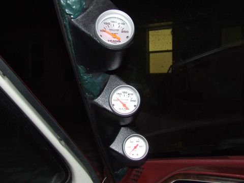 1990 Ford Bronco - A custom gauge pod is installed in the vehicle's interior, displaying transmission temperature, water temperature, and oil pressure reading…
