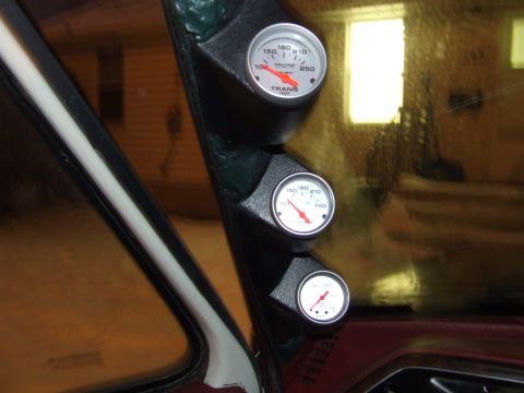 1990 Ford Bronco - A custom gauge pod is installed in a vehicle's interior, displaying transmission temperature and other readings.