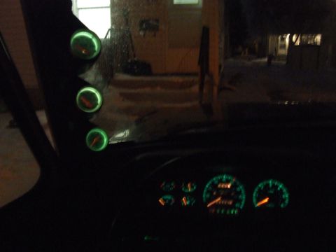 1990 Ford Bronco - Custom gauge pod with three glowing green gauges is visible inside the vehicle, along with the dashboard gauges.