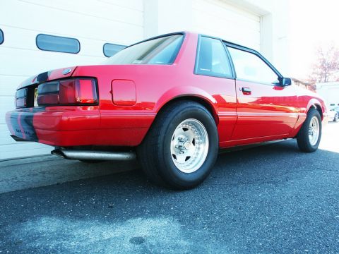 2001 Mercury Grand Marquis - This red coupe is equipped with racing slicks and has black stripes on its rear quarter panel.