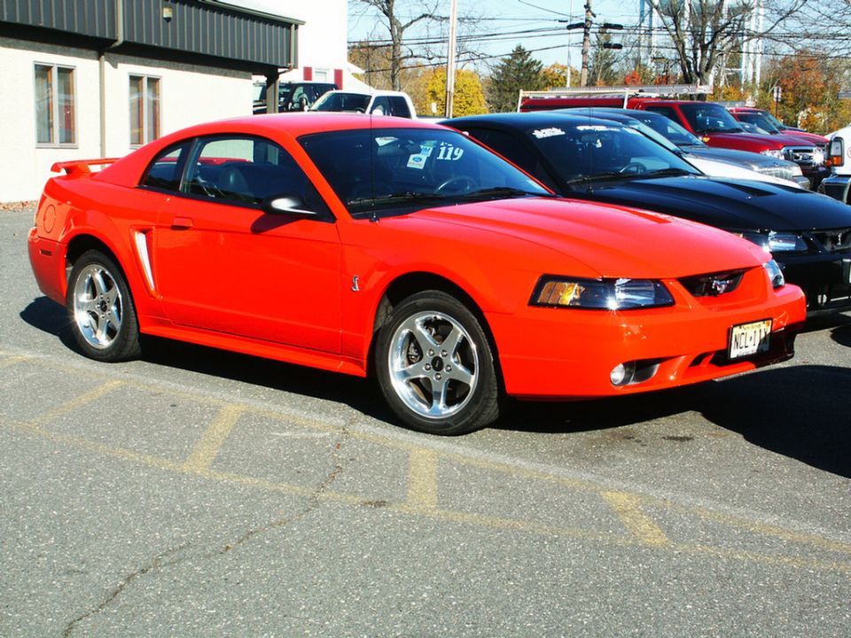Red 2001 Ford Mustang coupe parked outside