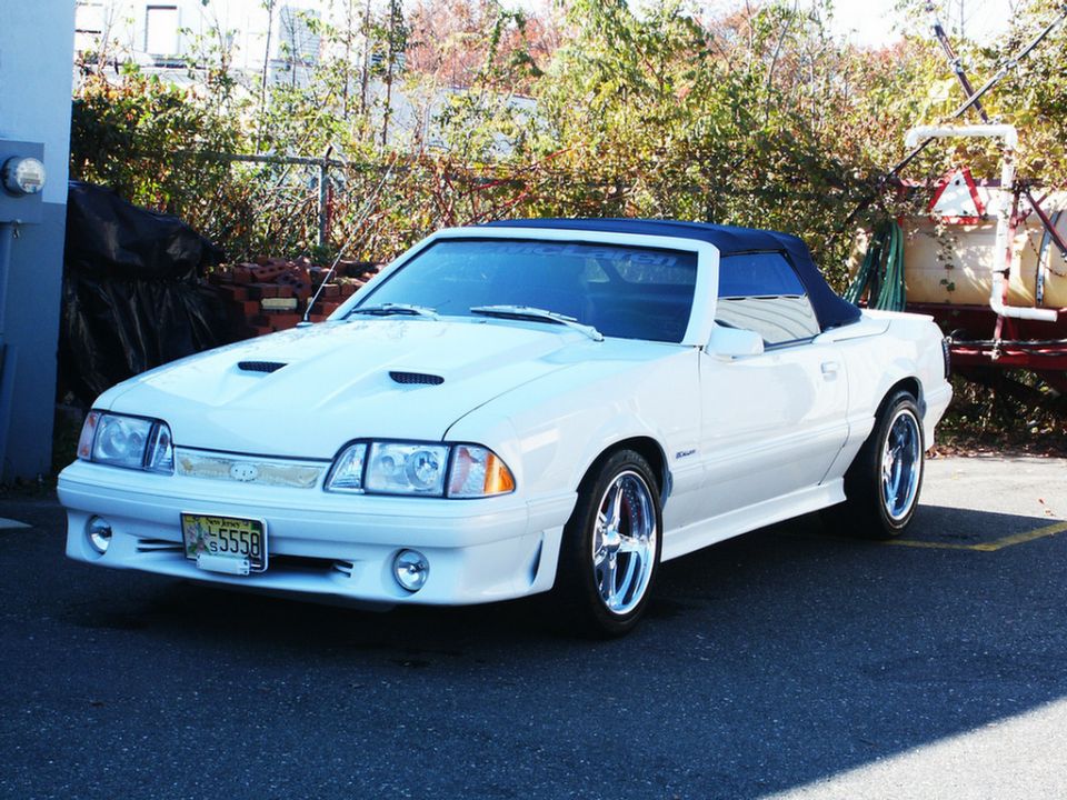 White convertible with hood scoops and chrome wheels