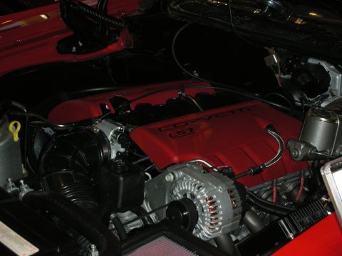 1998 Ford Crown Victoria - engine bay shows a red Corvette LS7 intake manifold cover and a chrome alternator inside a red-painted compartment.