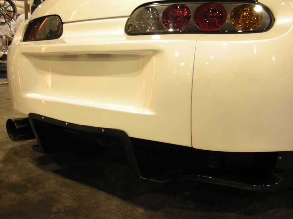 Rear bumper and diffuser of white Toyota Supra at indoor show