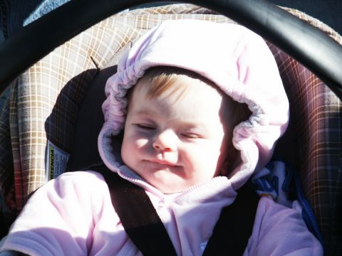 2001 Mercury Grand Marquis - A baby is secured in a car seat, facing forward with eyes closed.