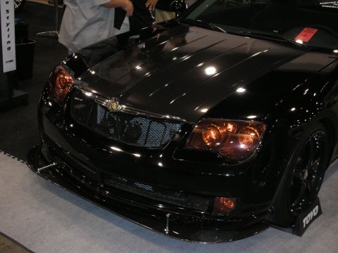 1998 Ford Crown Victoria - Front view of a black Chrysler Crossfire with a carbon-fiber hood, mesh grille, carbon splitter and amber-tinted headlights.