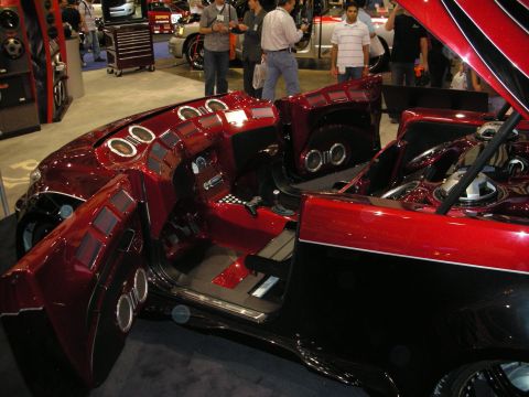 1998 Ford Crown Victoria - Elaborate candy-red custom show car interior packed with chrome-ringed audio speakers in the dash, doors and console.