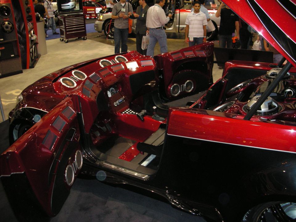 Deep-red custom car interior with multiple audio speakers in doors