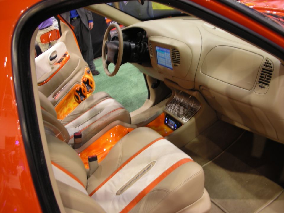 Custom tan-and-orange pickup interior with screen in dash