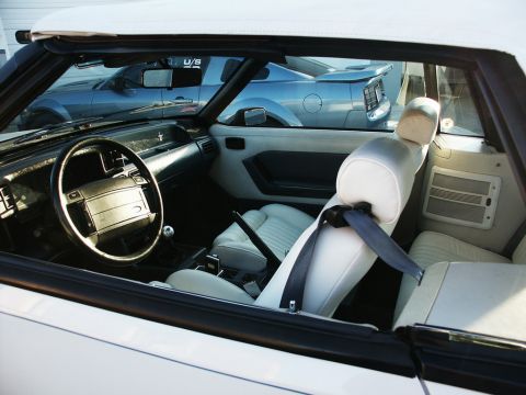 2001 Mercury Grand Marquis - The interior of a white convertible is shown, with another blue car visible through the windows.