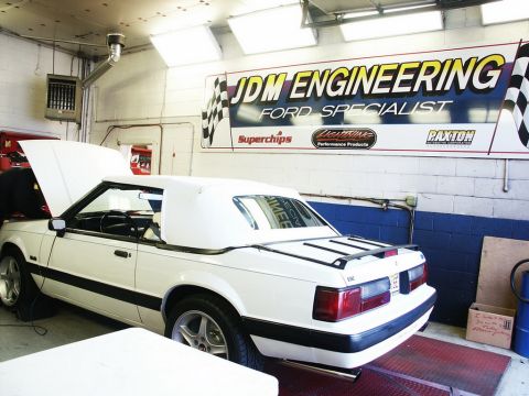 2001 Mercury Grand Marquis - A white convertible is on a dynamometer in a garage with the hood open, under a banner for JDM Engineering.