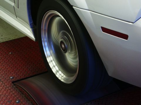 2001 Mercury Grand Marquis - A car's wheel is spinning on a dynamometer, indicated by the motion blur.