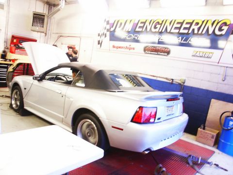 2001 Mercury Grand Marquis - A silver 2001 Ford Mustang convertible is positioned on a dynamometer in a garage setting.