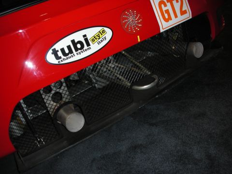 1998 Ford Crown Victoria - rear diffuser and twin center exhaust tips of a red Ferrari race car bearing a Tubi Style exhaust decal and GT2 class marking.