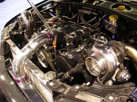 1998 Ford Crown Victoria - polished twin-turbo engine installation with mirror-finish intake piping, large turbos and carbon-fiber cowl trim.