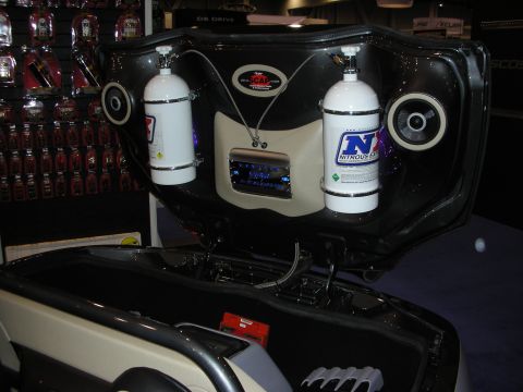 1998 Ford Crown Victoria - custom open trunk display mounting two nitrous bottles with NX decals, flanking speakers and a head unit at a vendor booth.