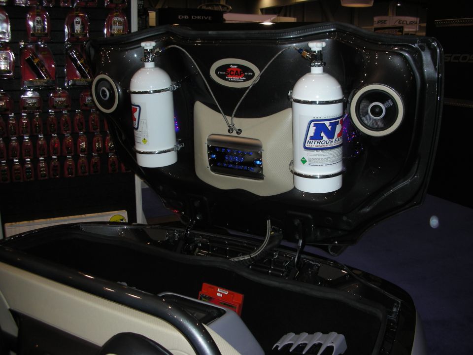 Open trunk display with two nitrous bottles, speakers and NX decals at booth