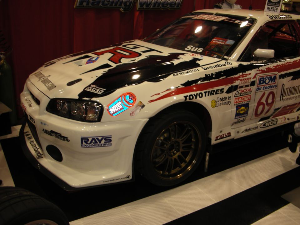 White Nissan Skyline race car with number 69 and sponsor decals
