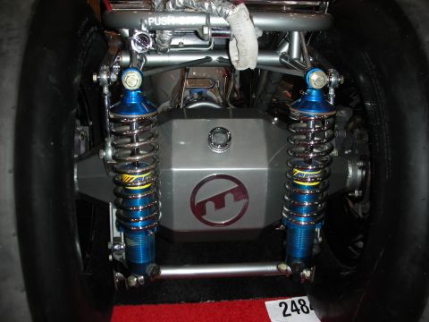 1998 Ford Crown Victoria - polished tube chassis rear suspension featuring twin blue coilover shocks and a center cover with a red logo.
