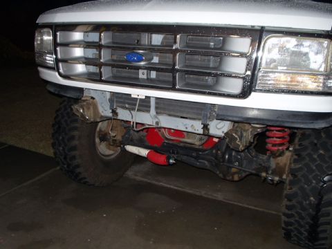 1993 Ford Bronco - Close-up of a 1992 Ford Bronco's front end, highlighting its grille and suspension components.