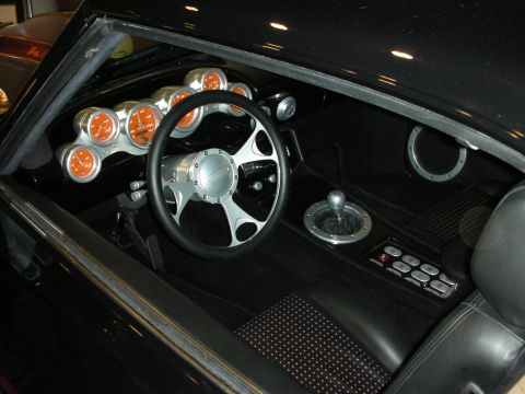 1998 Ford Crown Victoria - Custom convertible interior featuring a billet steering wheel, cluster of orange-faced gauges, chrome shifter and black seats.