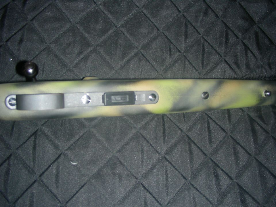 Camouflaged rifle receiver with bolt handle and magazine well