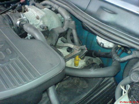 1994 Ford Thunderbird - Close-up view of engine components, including the air intake and various hoses.