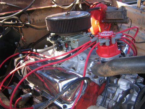1979 Ford Bronco - Close-up of an engine bay a carburetor, air filter, and ignition system components.
