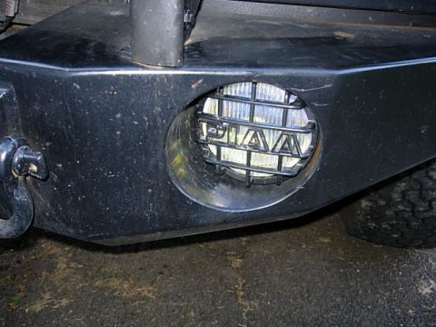 1993 Ford Bronco - Aftermarket bumper with PIAA fog light and tow hook visible.