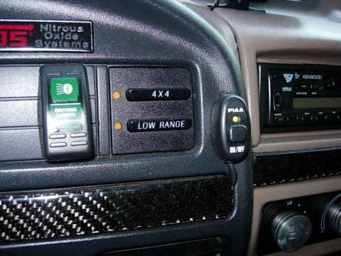 1993 Ford Bronco - The dashboard features aftermarket controls for driving lights, 4x4, and low range engagement.