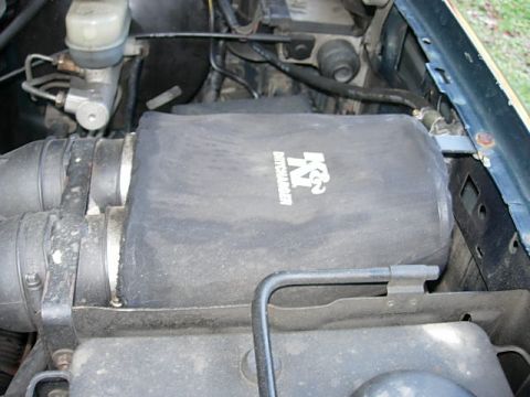 1993 Ford Bronco - Close-up of an engine bay showing a K&N air filter and brake fluid reservoir.