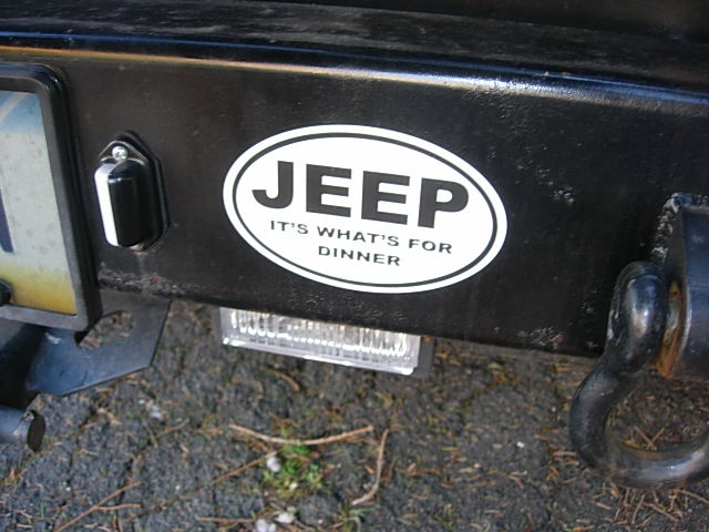 Jeep sticker that says 'IT'S WHAT'S FOR DINNER' on a black bumper