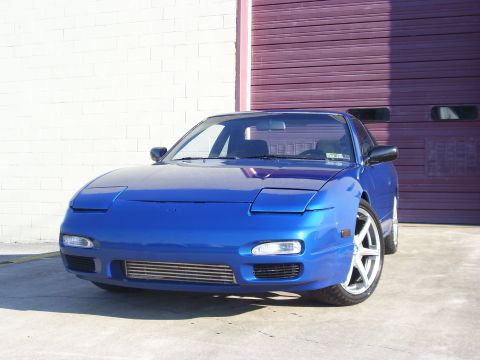 1993 Nissan 240SX - Front view of a blue 1993 Nissan 240SX coupe with aftermarket intercooler visible.