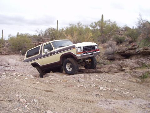 1993 Ford Bronco - This vintage Ford Bronco navigates a rocky desert trail, its off-road capabilities.