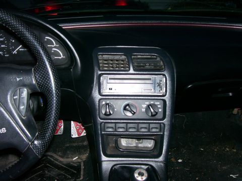 1993 Mazda MX-6 - The interior of a 1993 Mazda MX-6 is visible, including the dashboard, steering wheel, and center console.
