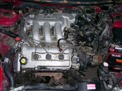 1993 Mazda MX-6 - Close-up of a Ford V6 engine, showing the intake manifold and various engine components.
