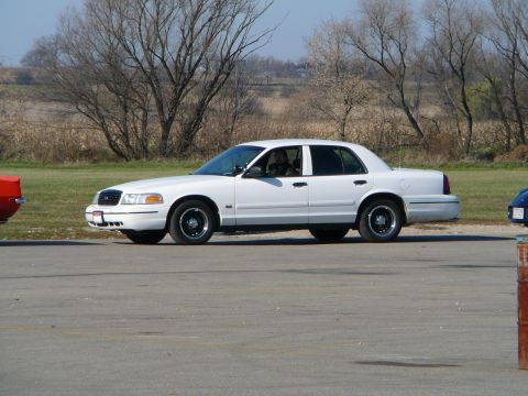 1997 Mercury Grand Marquis - A white 1997 Mercury Grand Marquis is seen from the side at an outdoor meet.