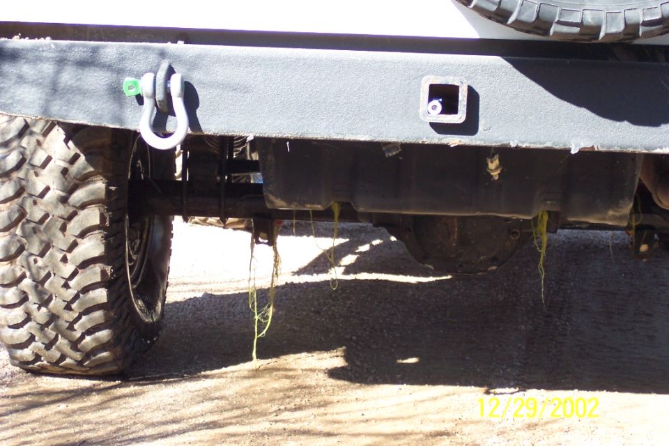 Underbody view of a steel bumper with D-ring shackle and receiver hitch