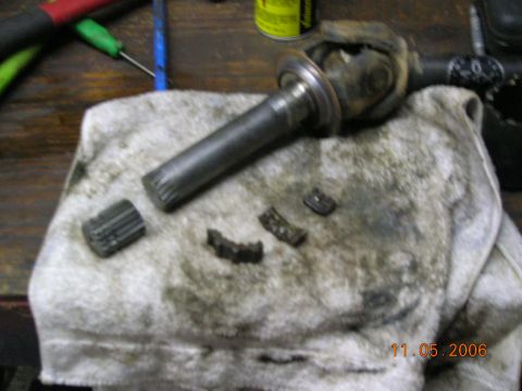 1985 Ford Bronco - Broken driveshaft components and a U-joint lie on a stained rag, with a date stamp of 11.05.2006.