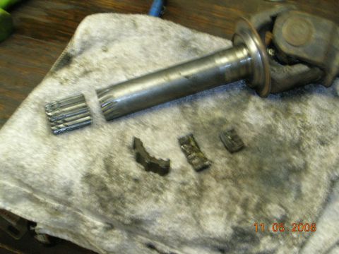 1985 Ford Bronco - Damaged driveshaft U-joint and yoke components shown on a cloth.