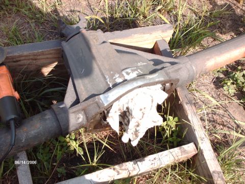 1982 Ford F-100 - Differential axle housing with a rag stuffed in it, resting on wooden supports.