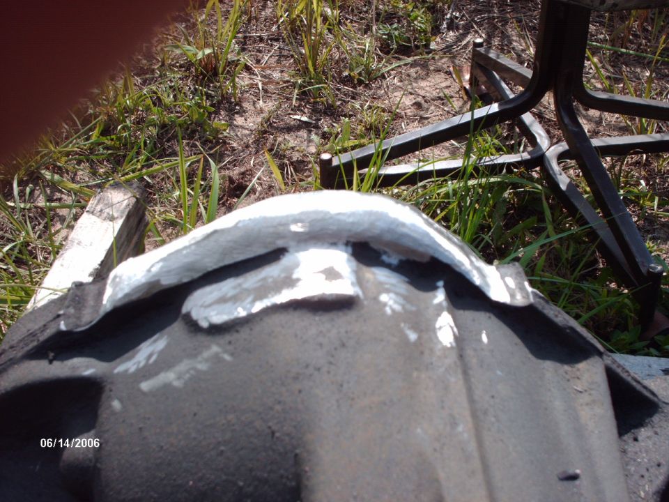 close-up of a differential housing with white putty applied