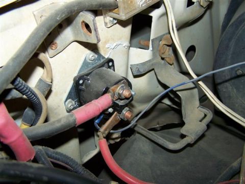 1995 Ford Bronco - Close-up view of the starter solenoid and associated wiring within the engine compartment.