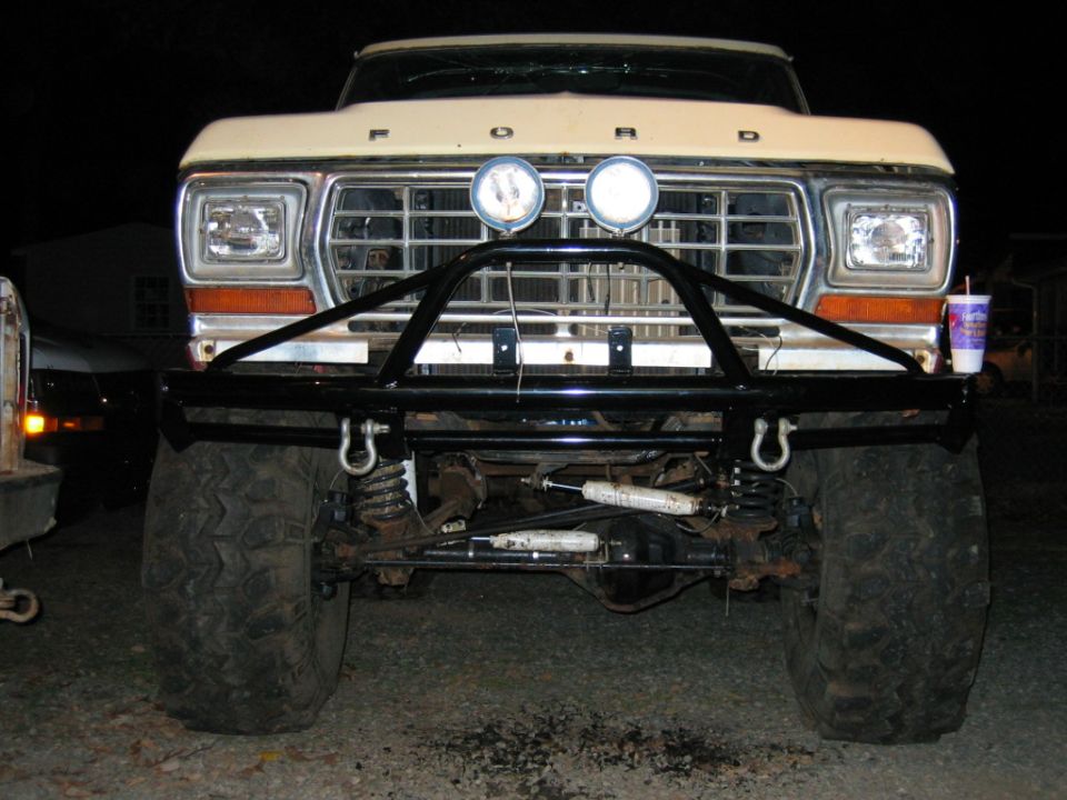 Ford truck front view with aftermarket bumper and large tires