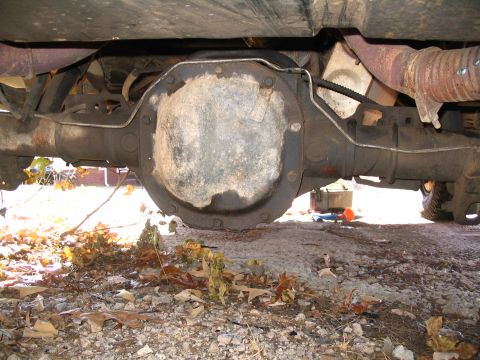 1984 Ford Bronco - The rear axle differential of a vehicle is shown from underneath, with the exhaust system visible.